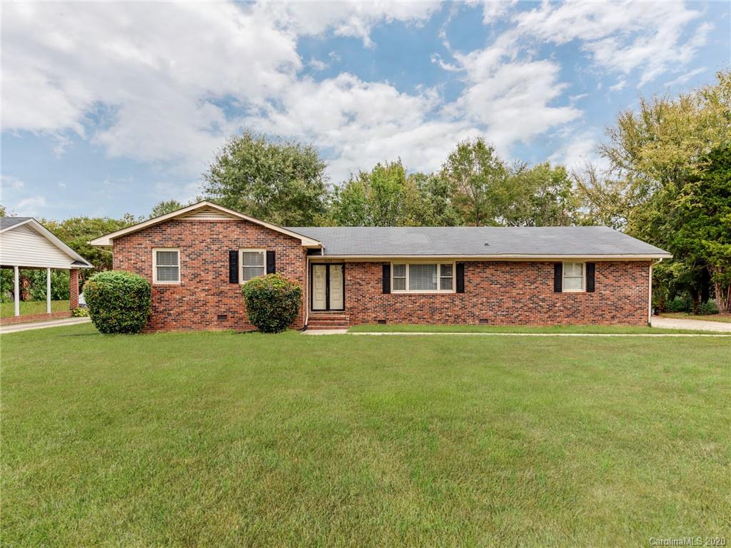10128 Mt Holly Road Charlotte, NC 28214 - Photo 1 of 24 a front view of a house with a garden