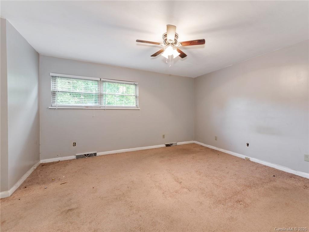 10128 Mt Holly Road Charlotte, NC 28214 - Photo 14 of 24 an empty room with windows and fan