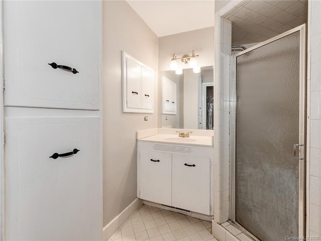 10128 Mt Holly Road Charlotte, NC 28214 - Photo 16 of 24 a bathroom with a double vanity sink mirror and shower