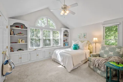 a bedroom with two beds and a chandelier