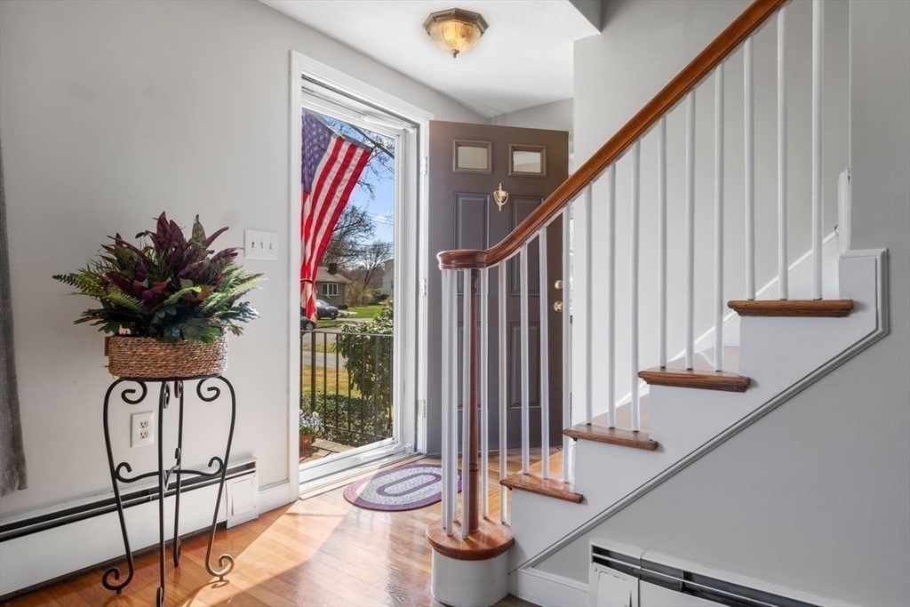 47 Irving Drive Walpole, MA 02081 - Photo 13 of 42 a view of staircase with wooden floor and chair