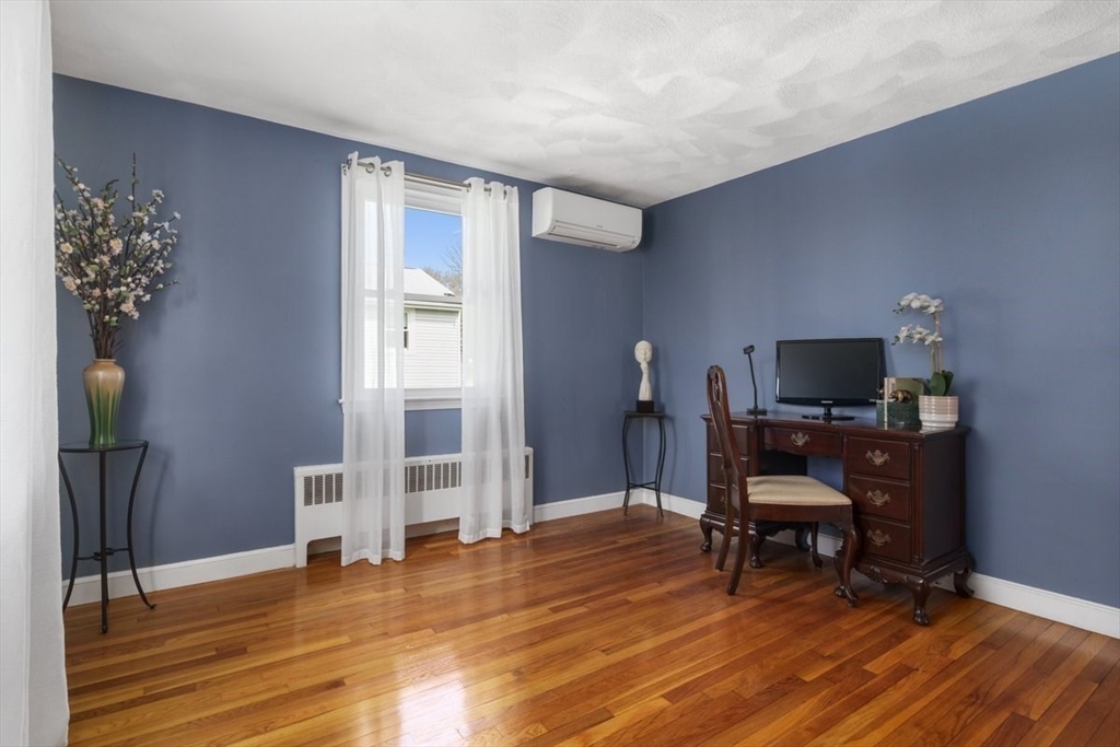 47 Irving Drive Walpole, MA 02081 - Photo 19 of 42 a view of a livingroom with furniture and a flat screen tv