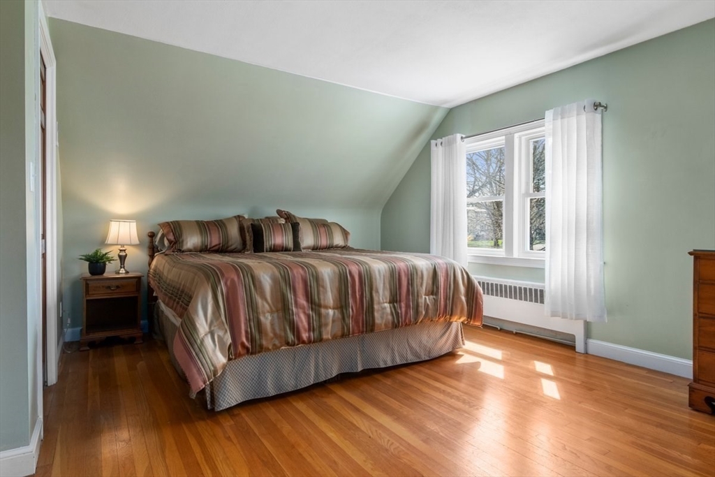 47 Irving Drive Walpole, MA 02081 - Photo 25 of 42 a bedroom with a bed and wooden floor