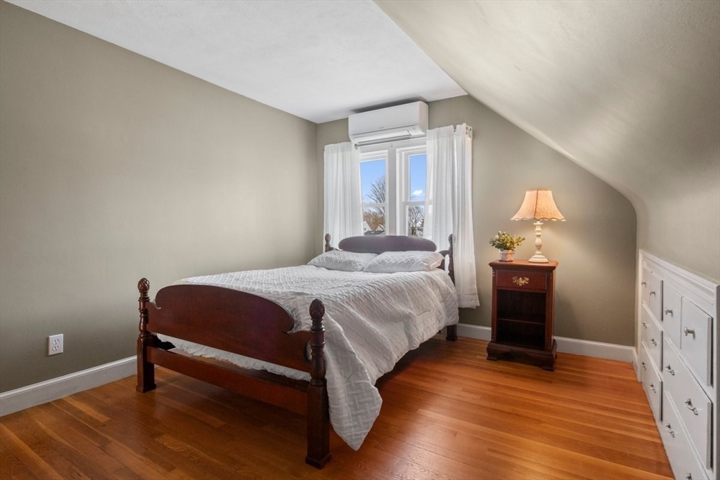 47 Irving Drive Walpole, MA 02081 - Photo 31 of 42 a bedroom with a bed and wooden floor