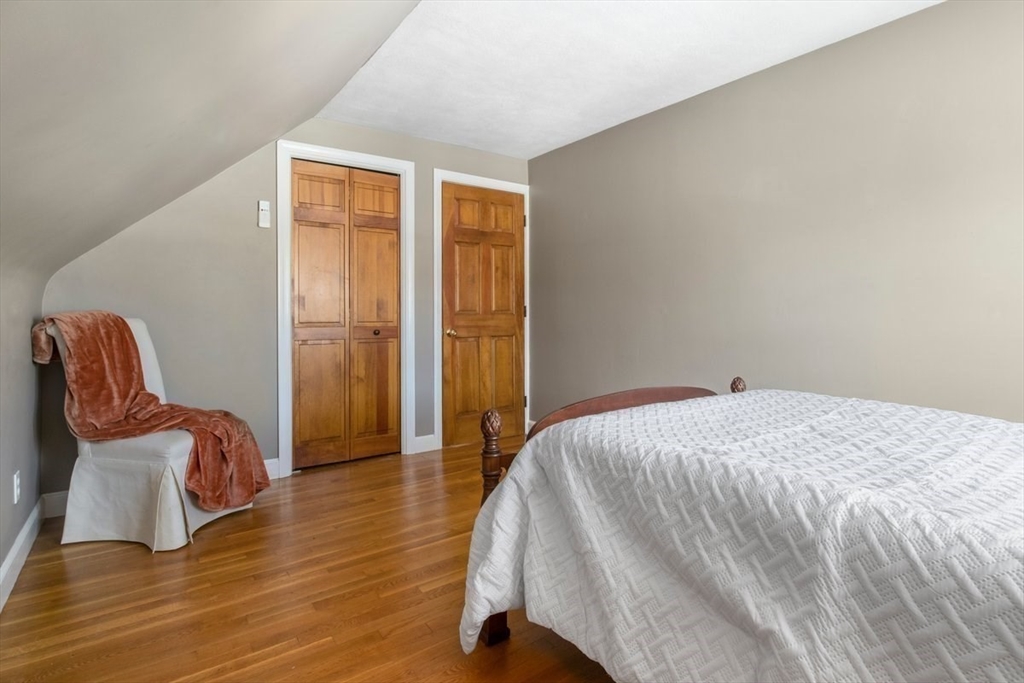 47 Irving Drive Walpole, MA 02081 - Photo 32 of 42 a bedroom with a bed and a chair