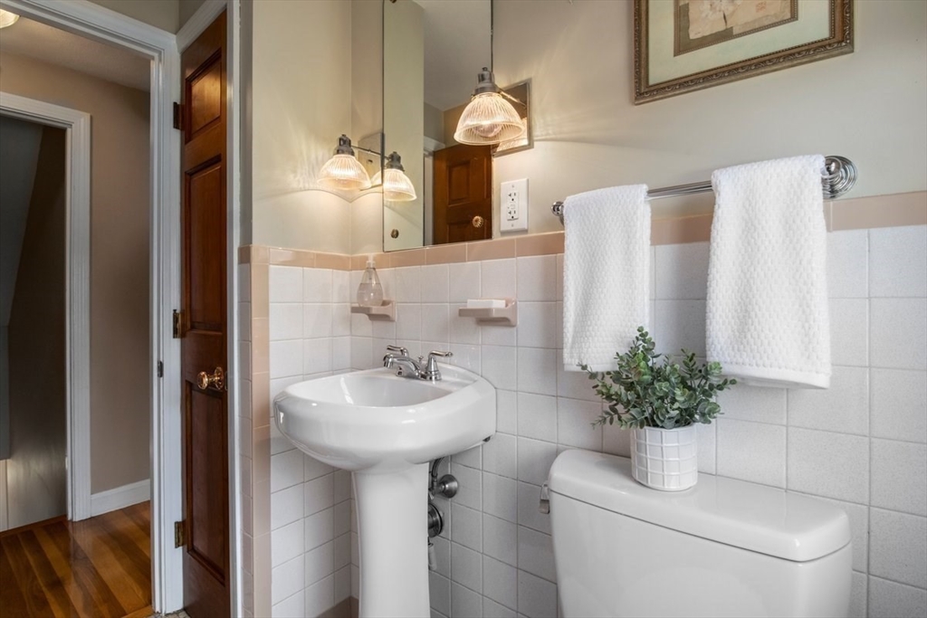 47 Irving Drive Walpole, MA 02081 - Photo 34 of 42 a bathroom with a sink a toilet and mirror