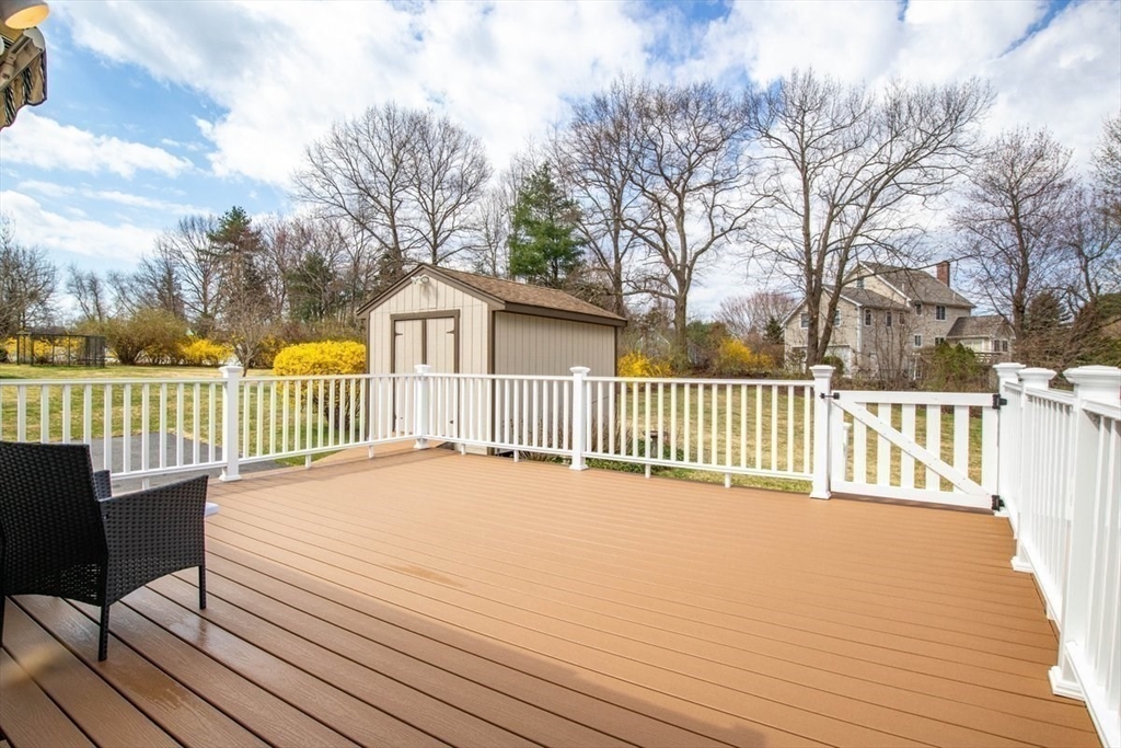 47 Irving Drive Walpole, MA 02081 - Photo 37 of 42 a view of a wooden deck and a yard