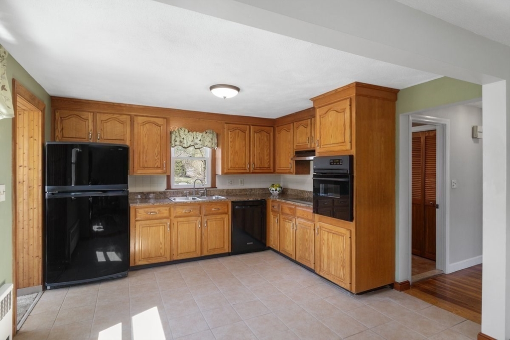 47 Irving Drive Walpole, MA 02081 - Photo 6 of 42 a kitchen with granite countertop a refrigerator and a stove top oven