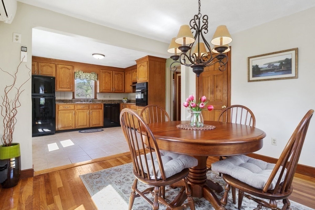 47 Irving Drive Walpole, MA 02081 - Photo 9 of 42 a dining room with furniture a chandelier and wooden floor