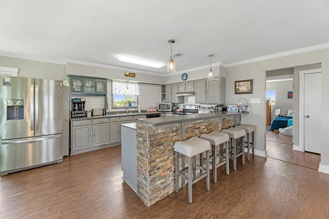 a view of a dining room with furniture and wooden floor