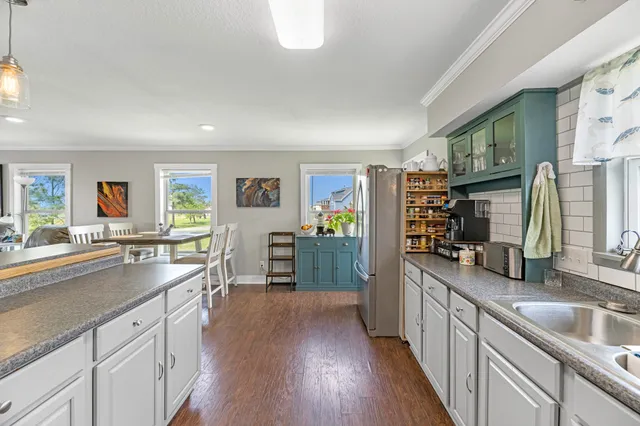 a stove top oven sitting inside of a kitchen