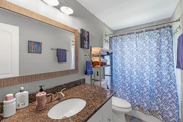 a bedroom with bed and a chandelier