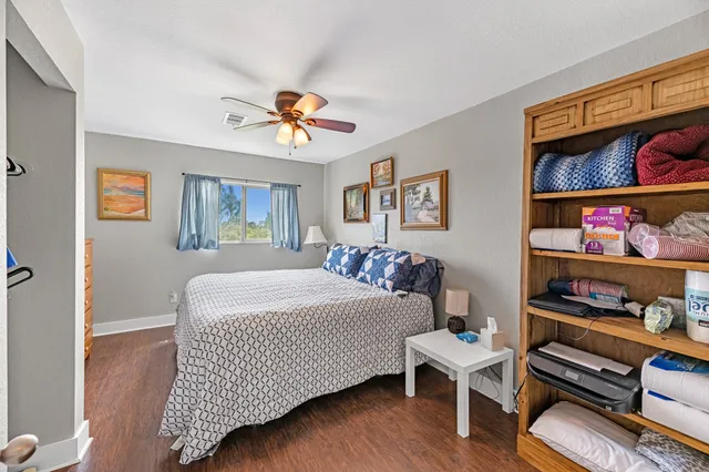 a bathroom with a granite countertop sink mirror vanity and toilet
