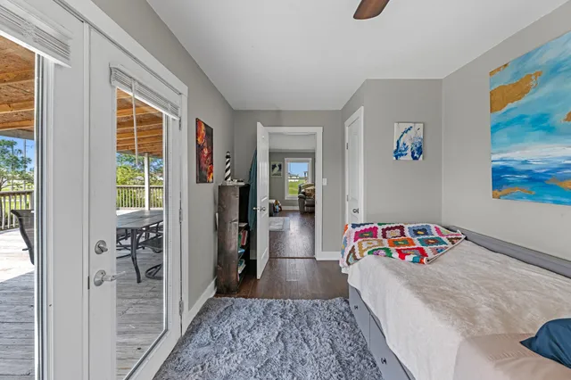 a bedroom with a bed and a painting on the wall