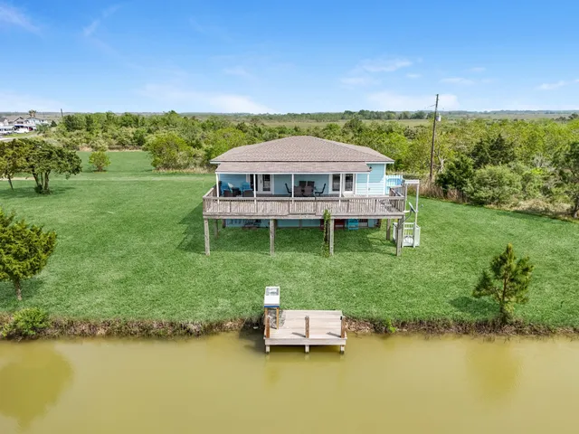 a view of a garden with a table under an umbrella