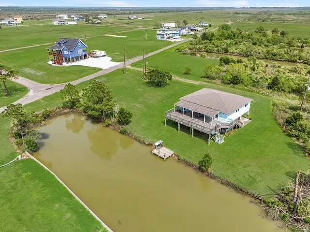 an aerial view of a houses with a yard
