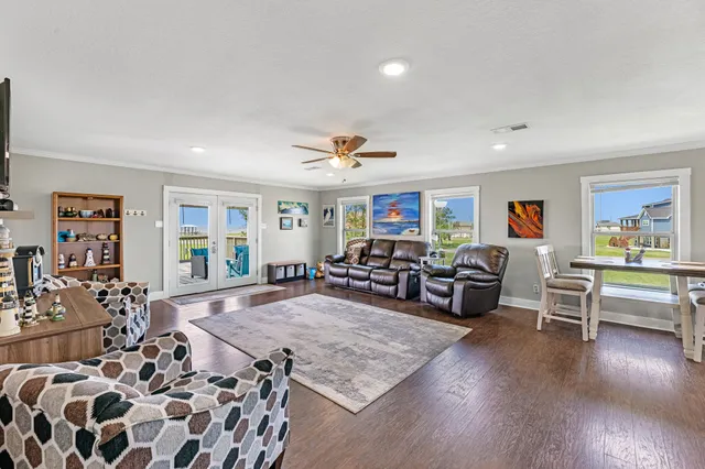 a living room with furniture and a wooden floor