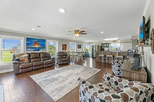 a living room with lots of furniture and wooden floor