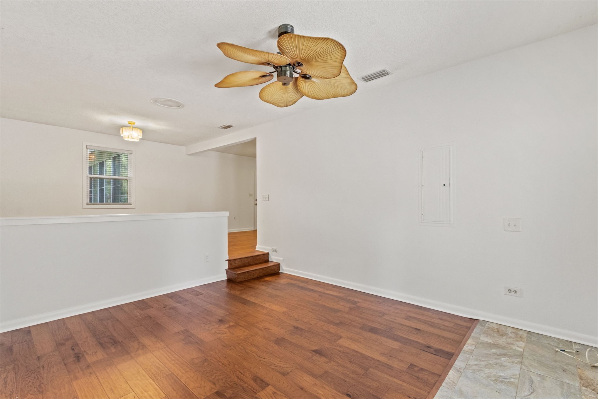2441 Amelia Road Fernandina Beach, FL 32034 - Photo 23 of 36 a view of a room with wooden floor and a ceiling fan