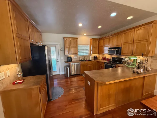a kitchen with sink a refrigerator and cabinets