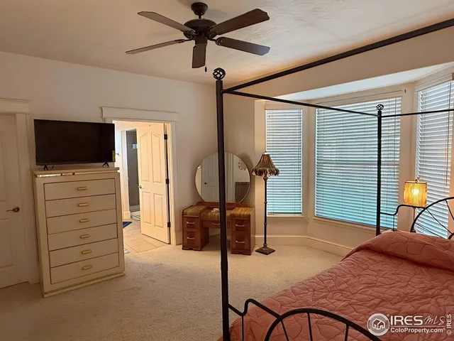 a bedroom with furniture and a flat screen tv