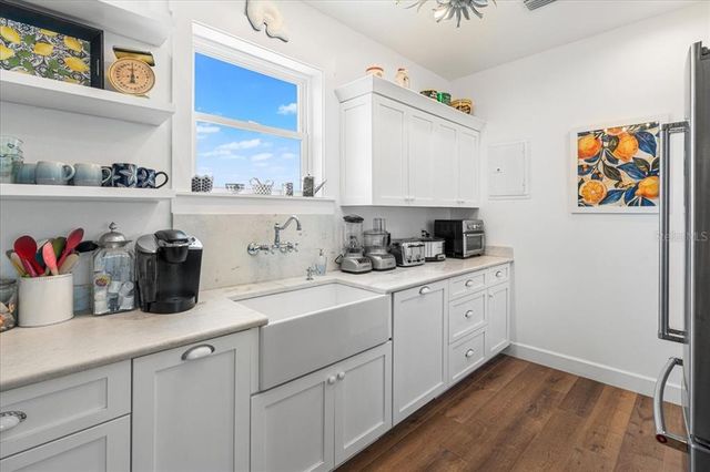 a kitchen with stainless steel appliances a sink stove and cabinets