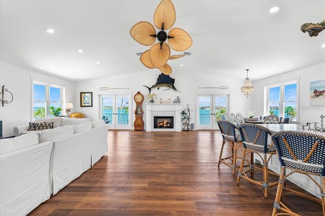 a living room with fireplace furniture and a wooden floor