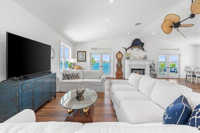 a living room with furniture kitchen view and a fireplace