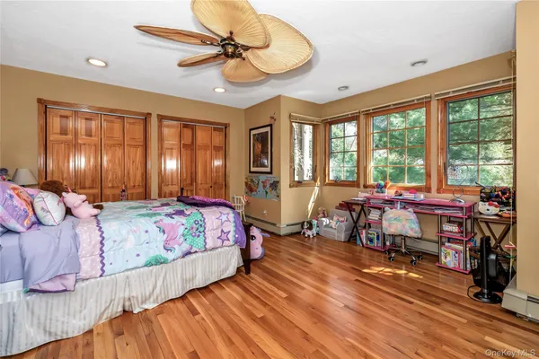 a bedroom with a bed and large windows