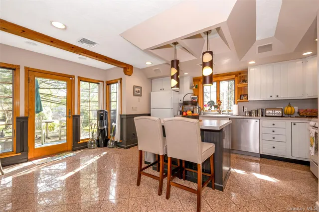 a dining area with a large window and table