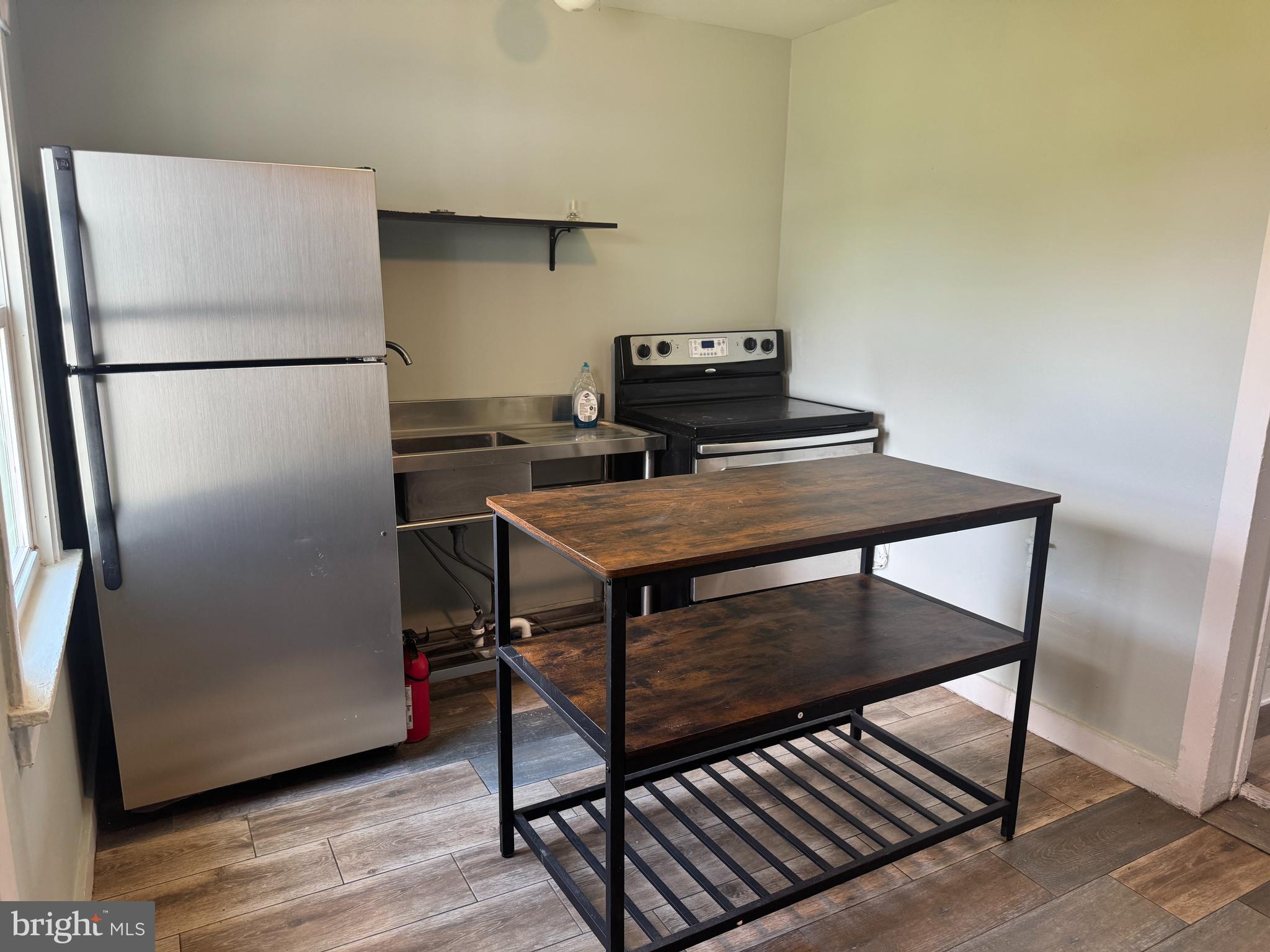 3754 Baltimore Pike, Unit 3 Littlestown, PA 17340 - Photo 9 of 21 a room with a table and a refrigerator