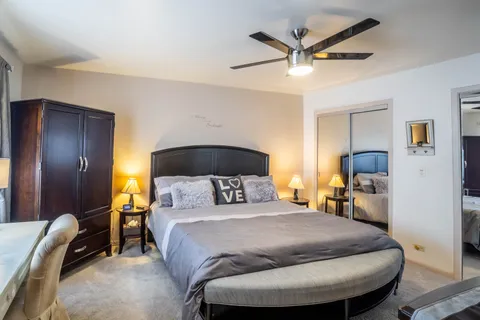 a bedroom with a bed and a chandelier