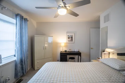 a bedroom with a bed and a chandelier
