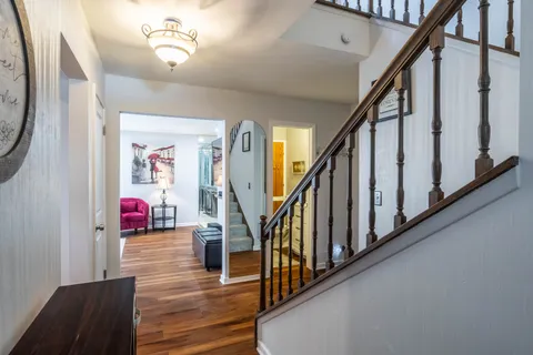 a view of entryway and hall with wooden floor