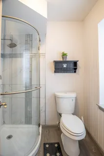 a bathroom with a toilet and a shower