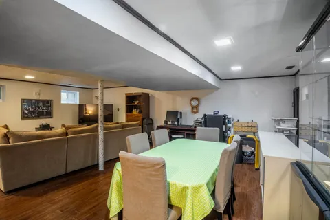 a view of a dining room with furniture a kitchen and chandelier