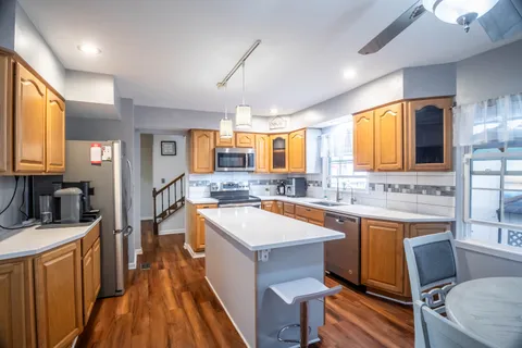 a large white kitchen with a large window