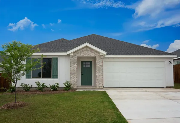 a view of a house with a yard and tree