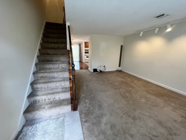 a view of an empty room with stairs