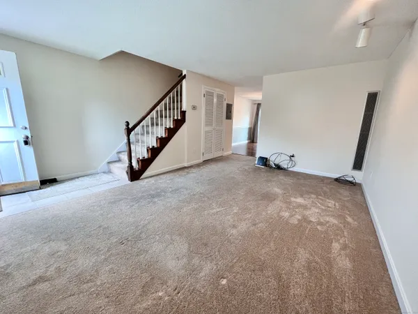 a view of an empty room with stairs