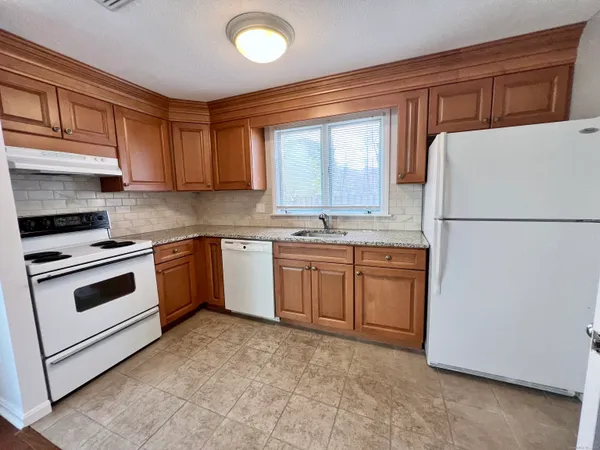 a kitchen with a white cabinets and white appliances