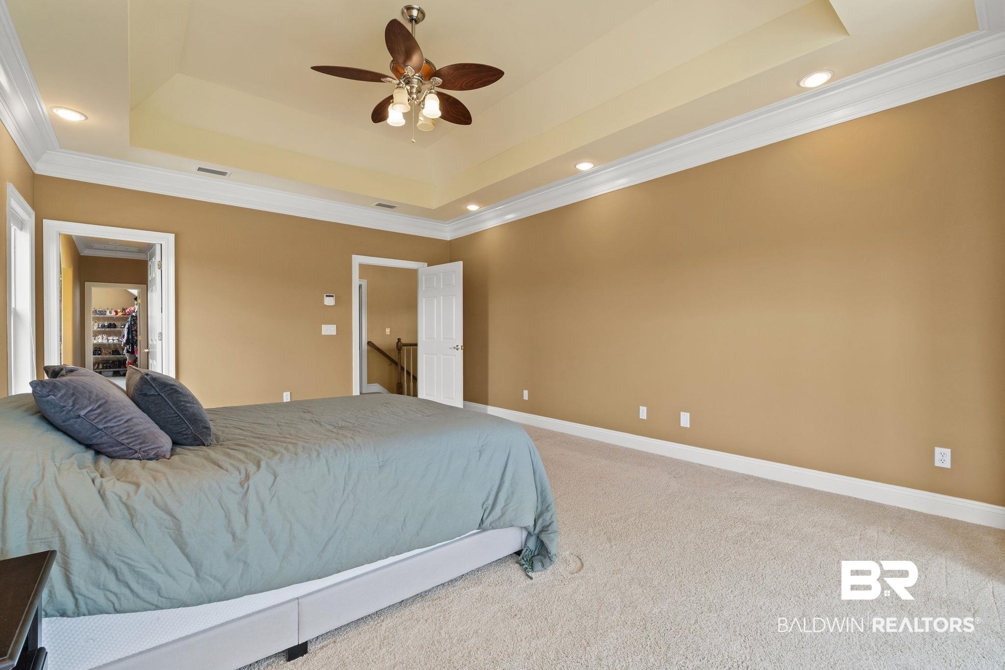 9790 Stucki Road Elberta, AL 36530 - Photo 62 of 72 Bedroom with a raised ceiling, carpet flooring, recessed lighting, crown molding, and baseboards