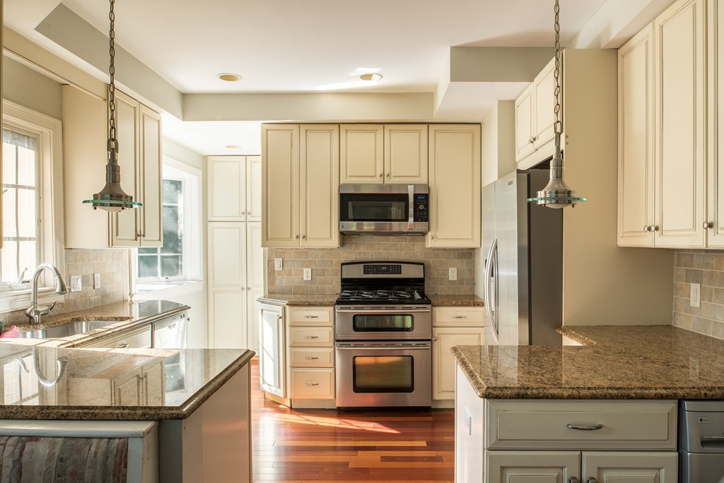 78 Winthrop Road Brookline, MA 02445 - Photo 4 of 14 a kitchen with stainless steel appliances granite countertop a stove a sink and a microwave