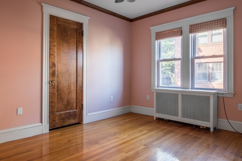 78 Winthrop Road Brookline, MA 02445 - Photo 8 of 14 an empty room with wooden floor and windows