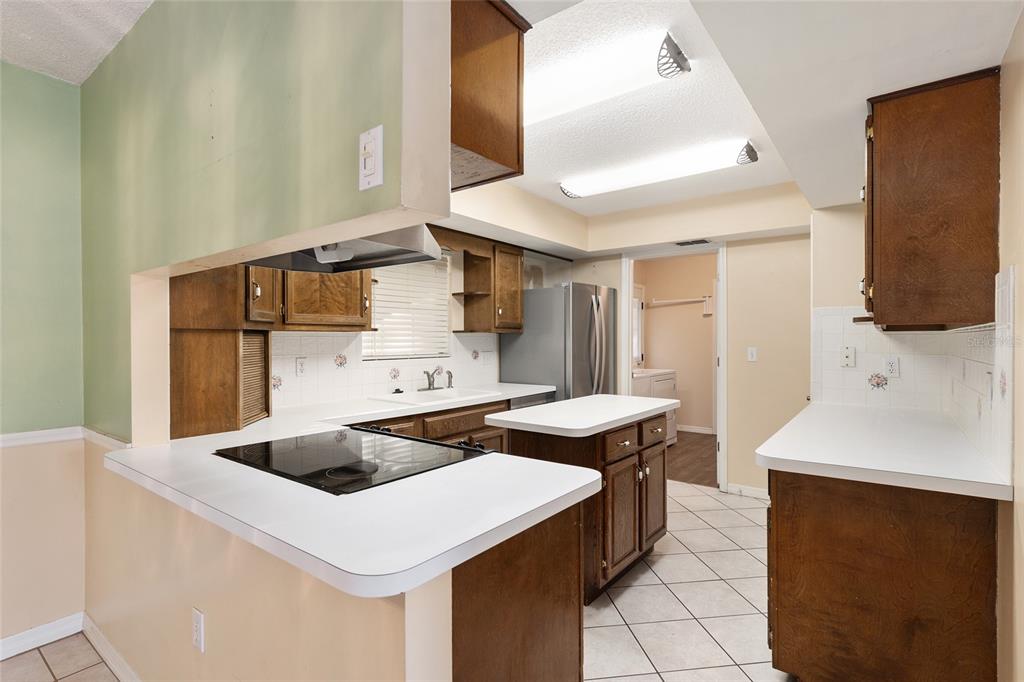 3300 Southeast 32nd Street Ocala, FL 34471 - Photo 14 of 51 a kitchen that has a sink and a stove in it