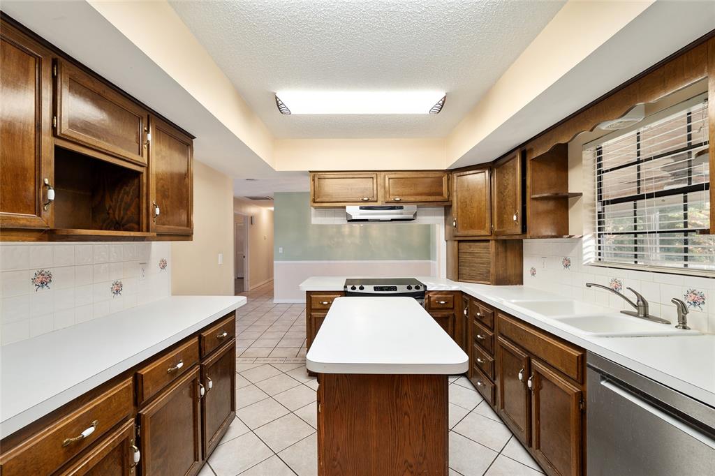 3300 Southeast 32nd Street Ocala, FL 34471 - Photo 18 of 51 a kitchen with a sink a stove and cabinets