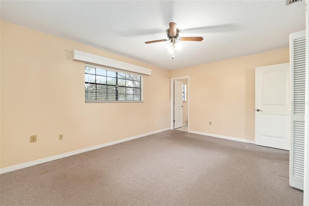 3300 Southeast 32nd Street Ocala, FL 34471 - Photo 23 of 51 an empty room with windows and chandelier fan