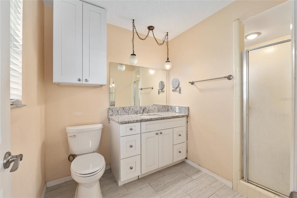 3300 Southeast 32nd Street Ocala, FL 34471 - Photo 24 of 51 a bathroom with a granite countertop toilet sink and mirror