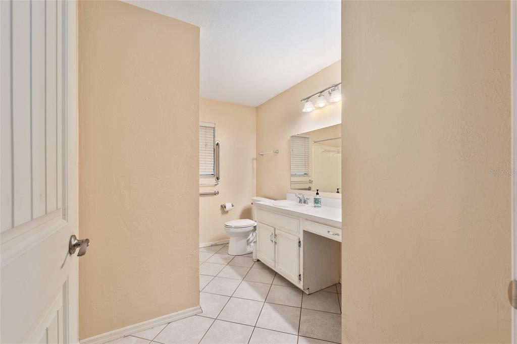 3300 Southeast 32nd Street Ocala, FL 34471 - Photo 30 of 51 a bathroom with a sink a toilet and a mirror