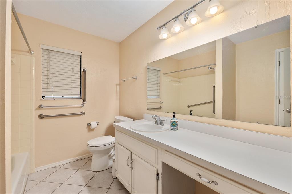 3300 Southeast 32nd Street Ocala, FL 34471 - Photo 31 of 51 a bathroom with a double vanity sink toilet and a mirror